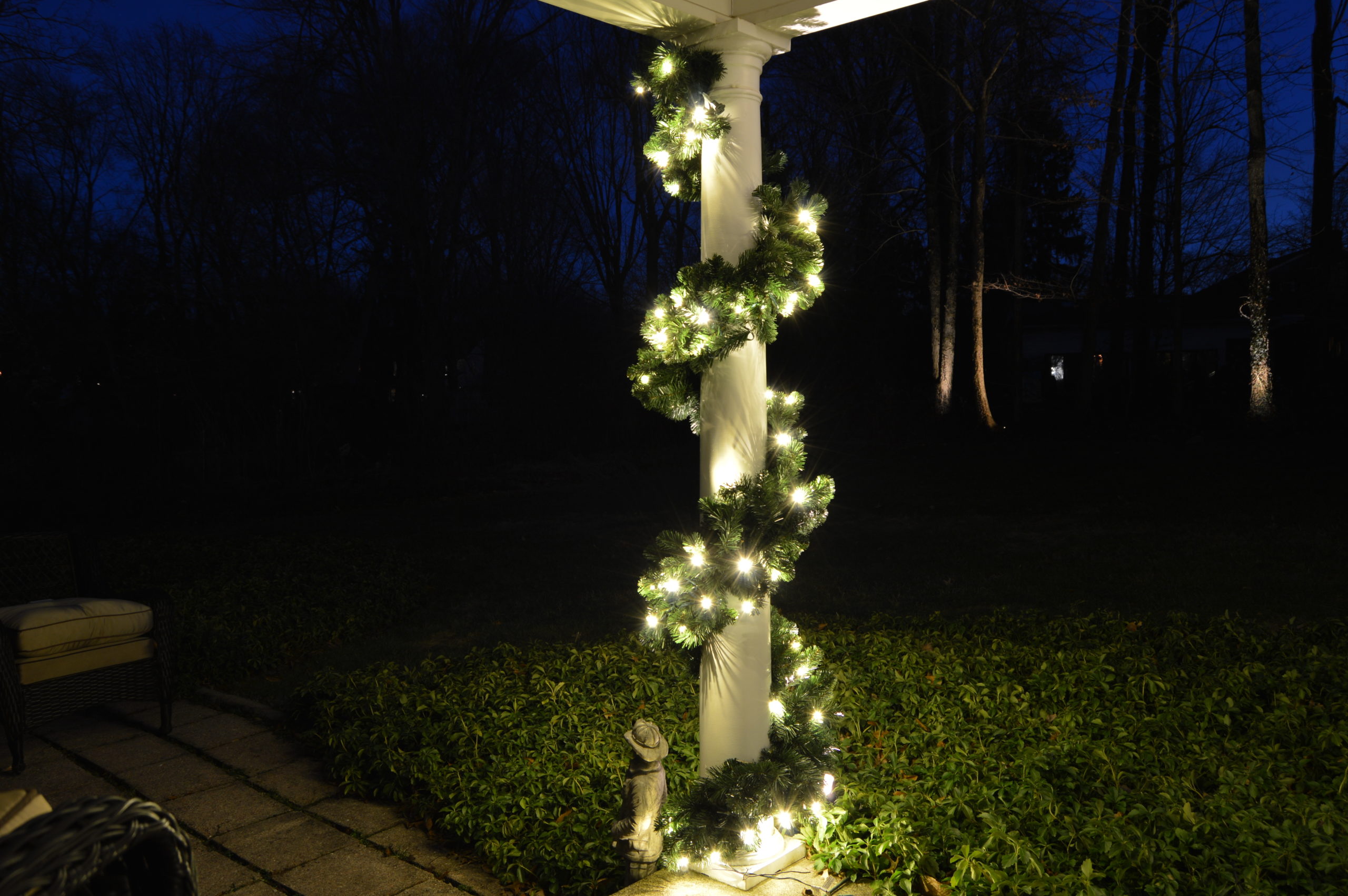 Holiday lighting on pilar of front porch of house
